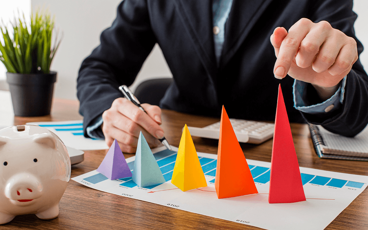 front view businessman with colorful cones representing growth 1